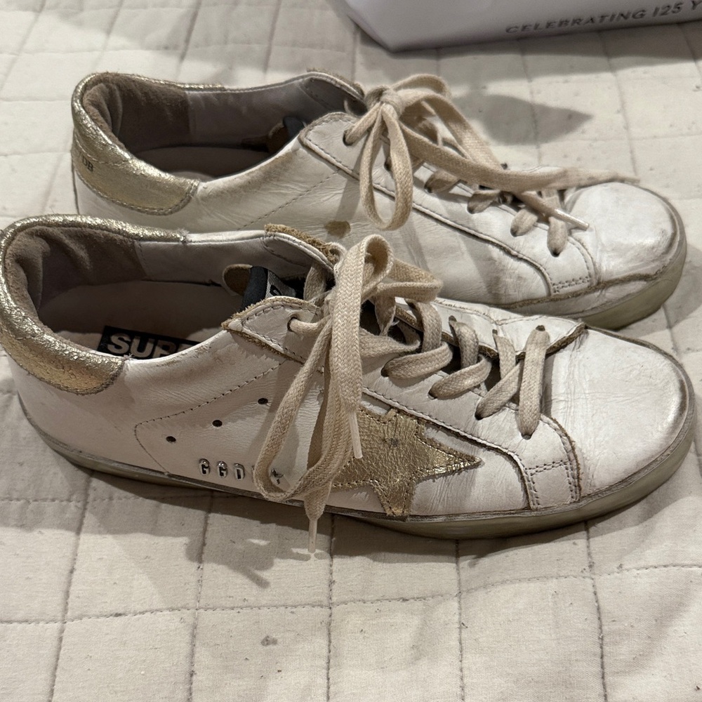Golden Goose superstar with gold metallic star and gold metal stud lettering